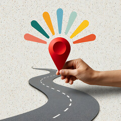 Hand placing red location pin brightly colored ideas bursting from map pin icon on winding road path