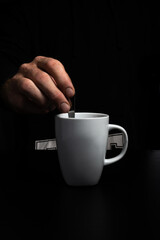 Hand Stirring hot beverage in Mug