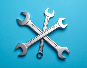 Crossed Chrome Wrenches on a Blue Background

