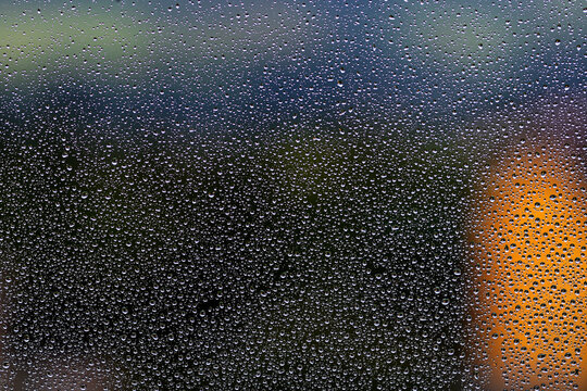 Raindrops on the window glass.