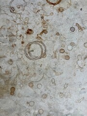 Wine Glass Rings and Spilled Stains on Rustic Stone Table Texture