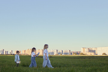 Children playing and reading in the field