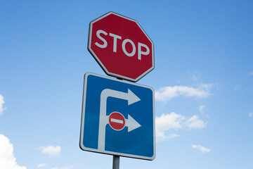 Stop sign paired with one way traffic sign highlights urban road safety and traffic control. These essential signs guide drivers and ensure smooth traffic flow in busy city streets