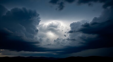 Naklejka premium Dramatic stormy sky with dark clouds and a glimmer of light. Moody and atmospheric landscape representing weather, nature, and power.