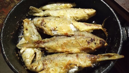 fried fish in a frying pan