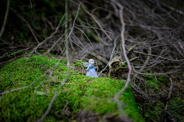 Child Angel on moss in the dark forest