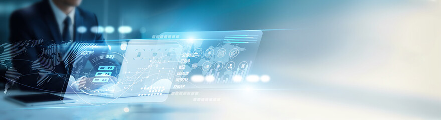 IT specialist using a laptop to configure web hosting servers, uptime monitoring, domain...
