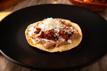 Ground beef tinga toast, a traditional Mexican home-cooked dish consisting primarily of beef cooked with chipotle chili and lots of onion, is traditionally eaten on 