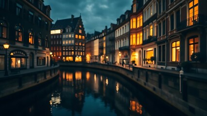 Fototapeta premium A nighttime canal scene with historic buildings reflected in water, glowing windows creating warmth.