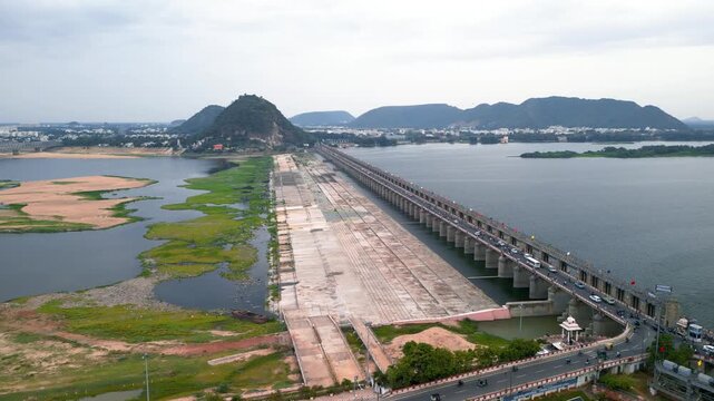 Aerial view of historic Prakasam barrage on the Krishna river connecting Vijayawada and Guntur districts at Vijayawada, India.