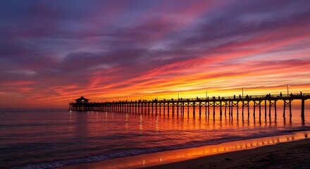 Obraz premium Dramatic Colorful Sunset Over a Coastal Pier.