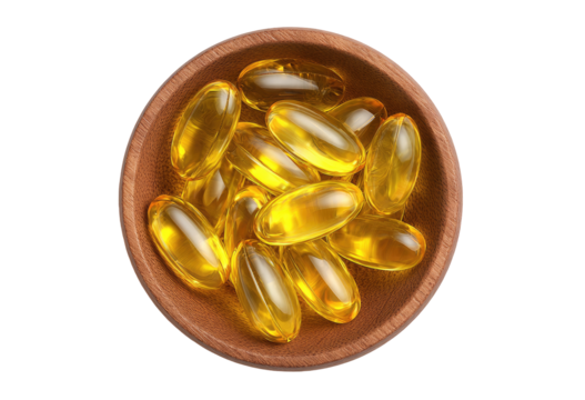 Yellow capsules in wooden bowl
