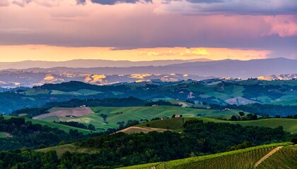 Rolling hills at sunset, layers of green and purple hues under a dramatic sky