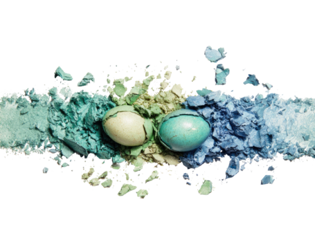 Powdered eyeshadows in teal, beige, and blue, with two eggs in the center