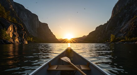 Fototapeta premium A Canoes Bow Points Towards a Radiant Sunset in a Majestic, Serene Fjord.
