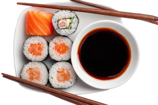 Assorted sushi rolls and soy sauce, served on a plate with chopsticks