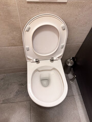 Modern toilet with open lid in tiled bathroom interior. Sanitation, hygiene, and cleanliness representing household utility, facility, and essential daily usage.