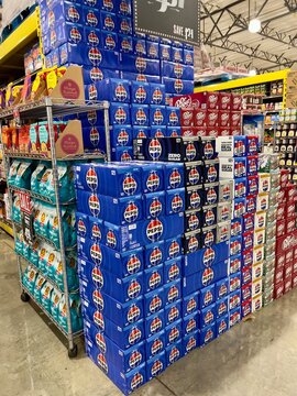 Pile of Cases of canned Pepsi sodas for sale at a local supermarket aisle	
