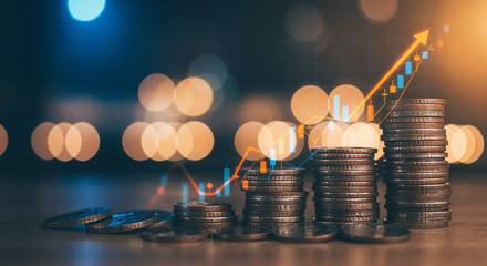 Stacks of coins with upward-trending financial chart against bokeh lights