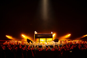 A stage with a light show and a crowd of people.