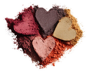 Four heart-shaped eyeshadows nestled in a pile of colorful powder