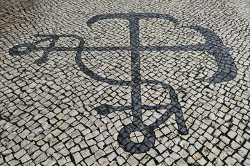 Traditional pattern cobblestone pavement (calçada portuguesa) with anchor in Portimao, Algarve,...