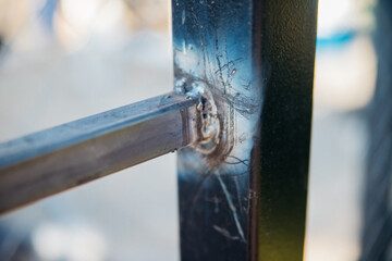 Close-up of a sturdy metal corner joint. Metal smelting.