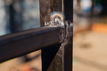 Close-up of a sturdy metal corner joint. Metal smelting.