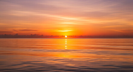Obraz premium A serene sunset over the ocean with vibrant orange and pink hues reflecting on the water surface ai generated