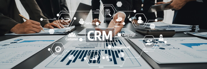 A professional business team collaborates to analyze charts and graphs, focusing on customer...