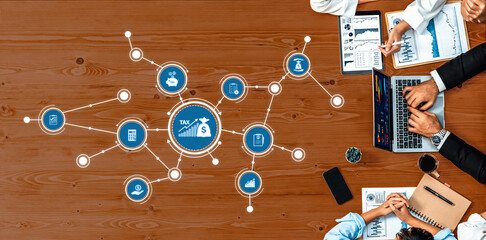 A dynamic business meeting focused on tax strategies, showing professionals using digital tools and data visualization for effective financial planning and collaboration. Amity
