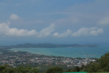 Fototapeta premium clouds over the city and blue sea