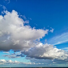 Fototapeta premium Vast blue sky with fluffy white clouds