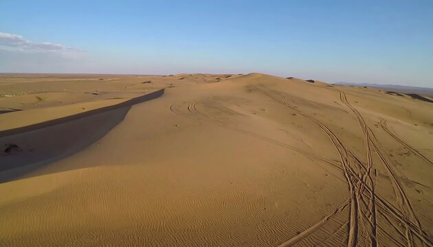 Vast desert dunes under a clear sky