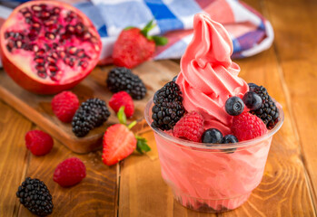 Strawberry ice cream cup with Raspberry, Mulberry, and Pomegranate side view of sweet treat