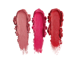 Three swatches of lipstick in varying shades of pink and red, against a black background.  Swatches are smudged, showing texture