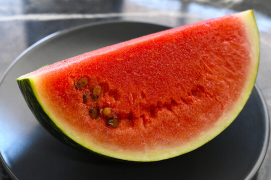 Watermelon slice on a plate. Fresh summer fruit. Healthy deit food.