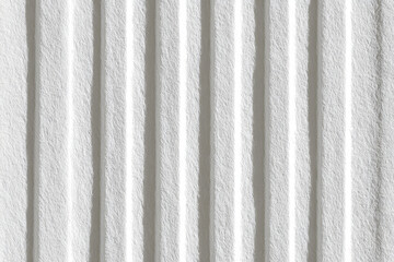 Close-up view of a textured, light gray surface with vertical ridges and faint white lines