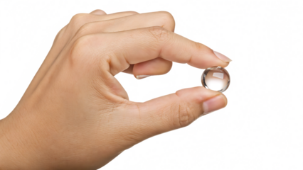 Hand holding small clear glass sphere isolated on a transparent background fingers