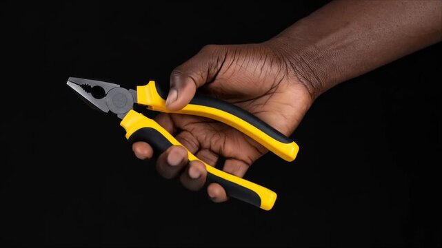 Handheld pliers in dark background