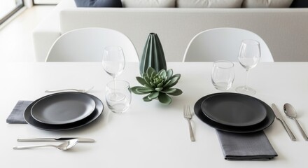 Minimalist Table Setting with Dark Plates, Green Succulent, and Modern White Furniture