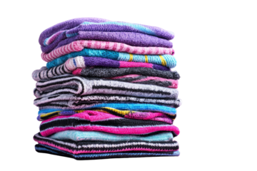 A stack of colorful, folded clothes.  Vibrant textiles in various patterns and hues, piled neatly against a black backdrop
