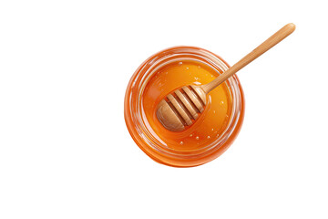 Overhead view of honey in a clear jar with a wooden dipper