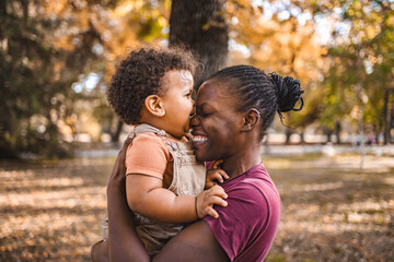 Fototapeta premium Mother's Embrace: Joyful Moments in the Park