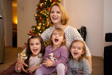 Joyful holiday gathering with family around a festive tree