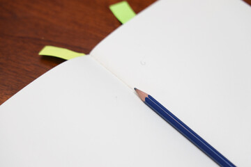 open notebook with pencil in the middle