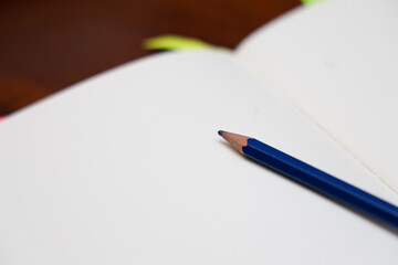 open notebook with pencil in the middle