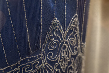 Tiny beads create a pattern on a dress in detail.

