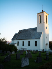 Small church in the countryside of Melbu Norway with gravestones