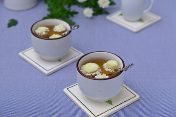 cups of tea with chrysanthemum flowers close-up